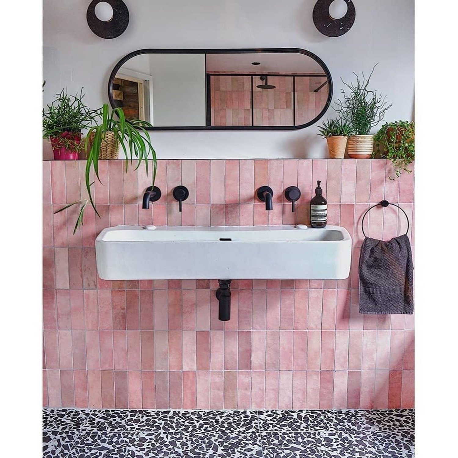 Stylish pink tiled bathroom wall with a modern rectangular sink