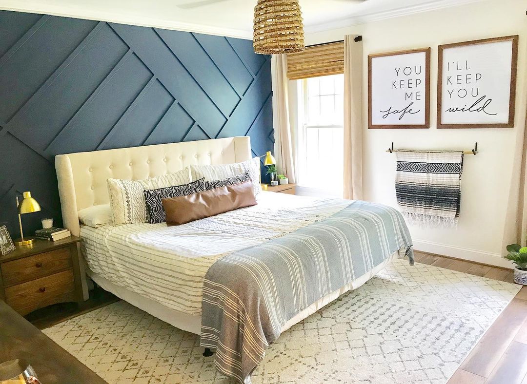 A chic and cozy bedroom with a geometric accent wall