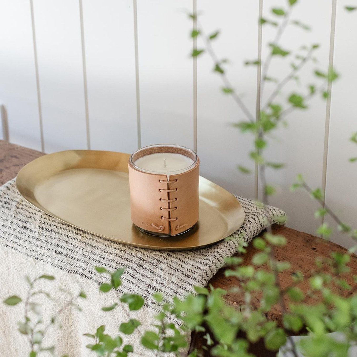 A serene home decor vignette featuring a scented candle