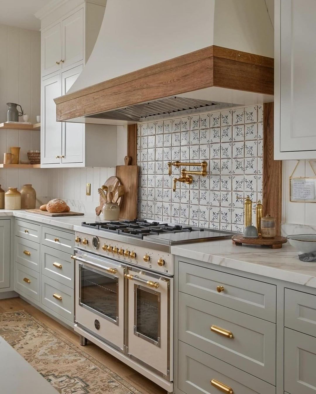 A chic and inviting kitchen space featuring two-tone cabinets and brass accents.