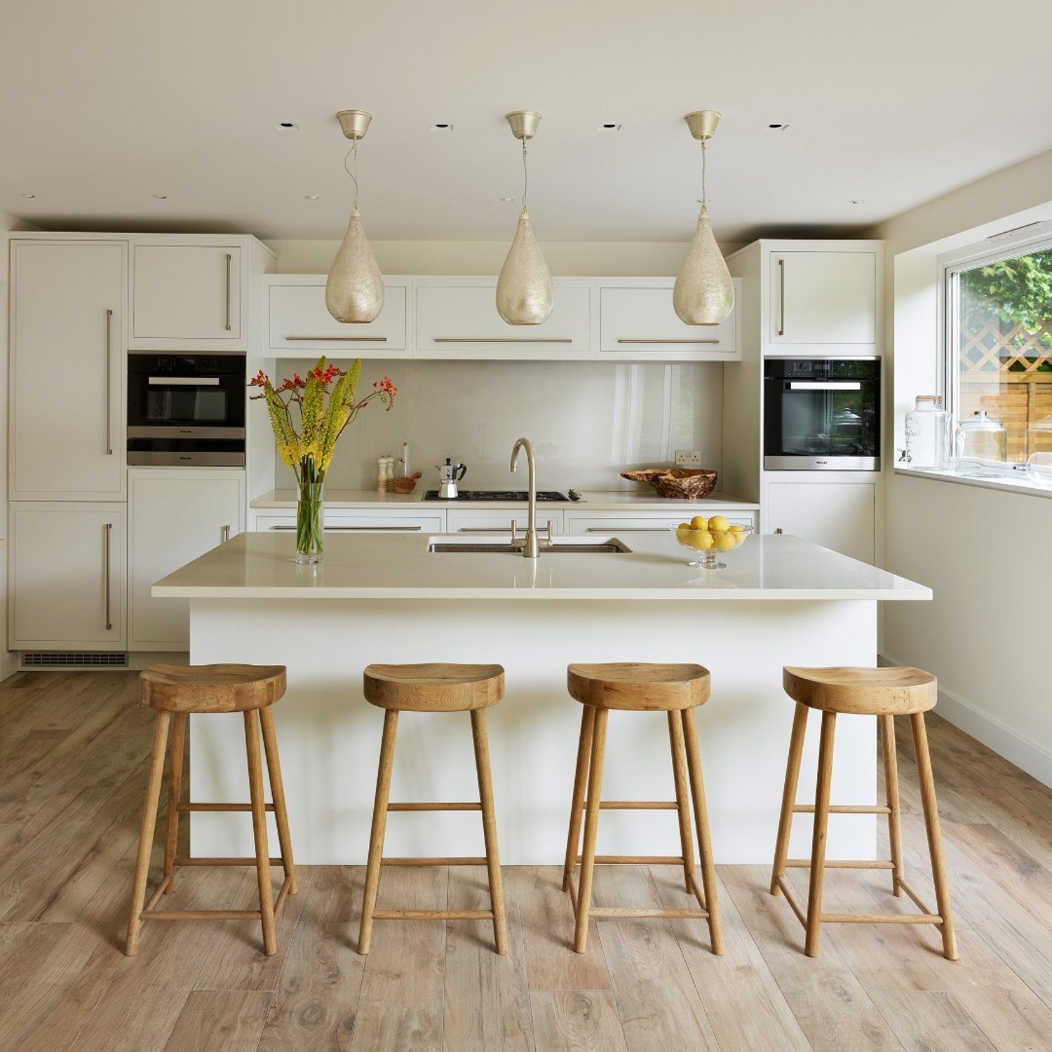 Stylish modern kitchen with wooden stools