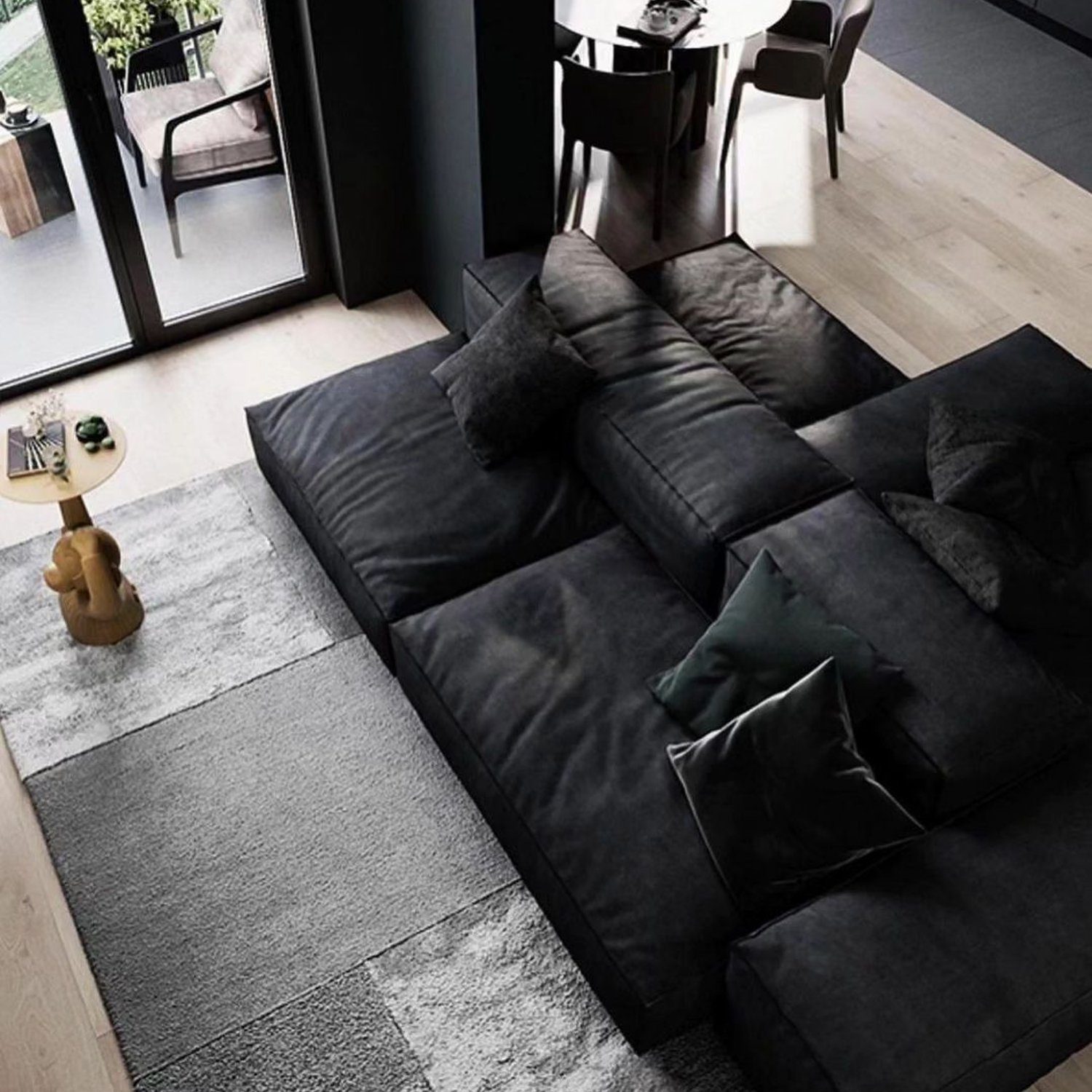 A sleek and modern living room featuring a large black sectional sofa