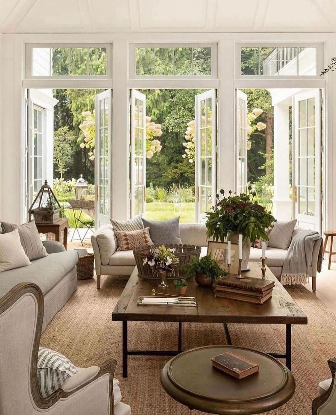 Cozy sunroom with large windows showcasing the garden