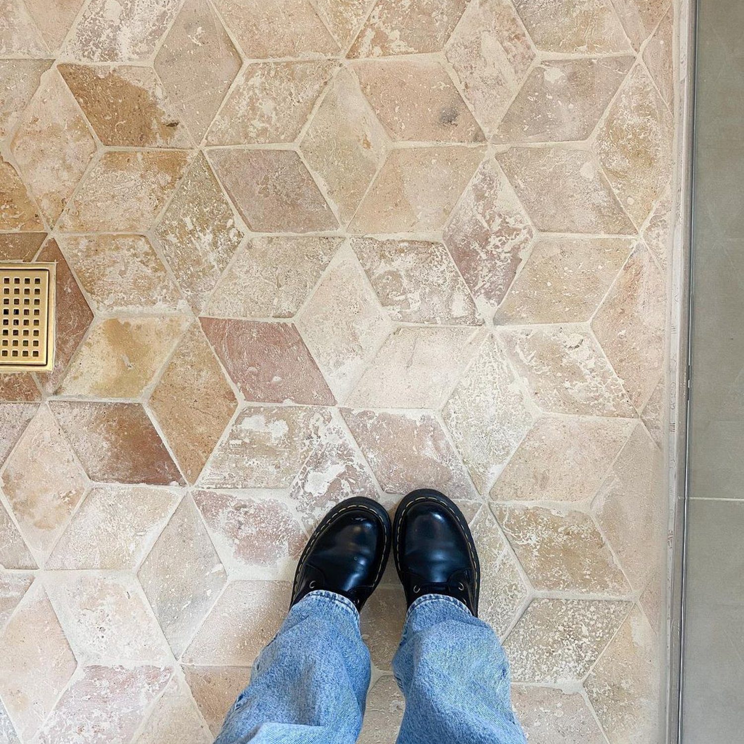 Elegant terracotta floor view with a glimpse of someone's feet