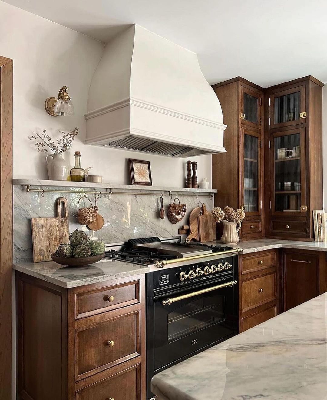 Classic style kitchen with rich wooden cabinets and marble countertops