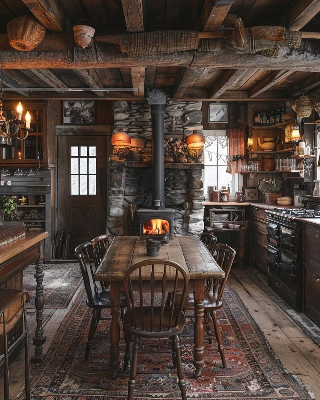 A cozy traditional kitchen featuring dark wooden furniture and a warm fireplace