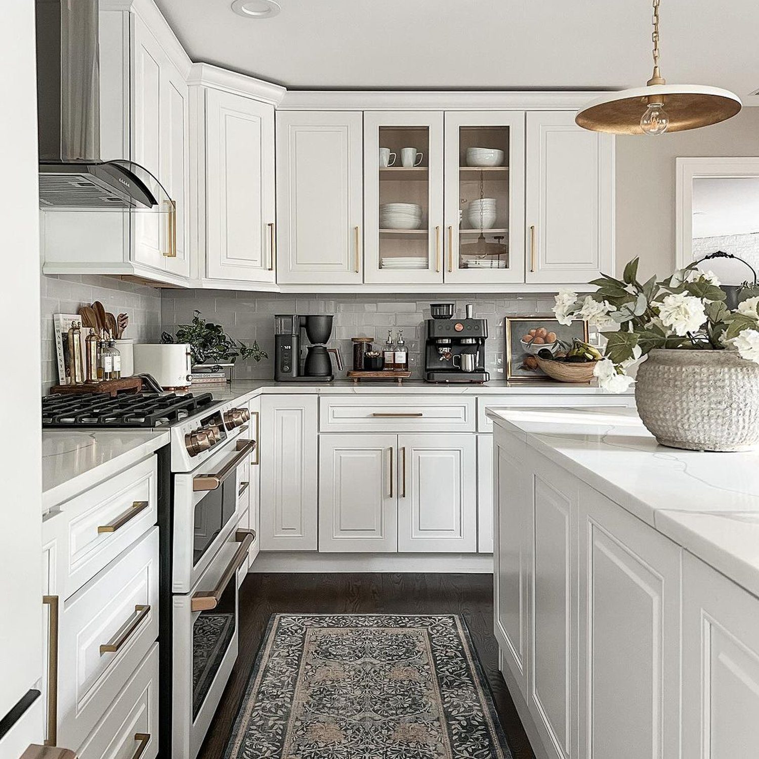 Elegant and functional kitchen design with two-tone cabinetry and gold accents