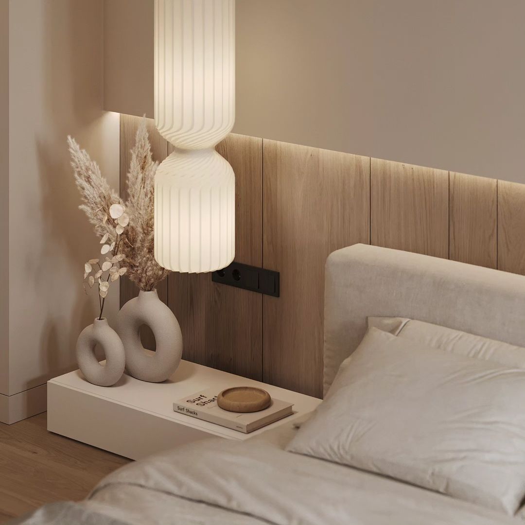 A minimalist bedroom with a natural wood headboard and textured decor