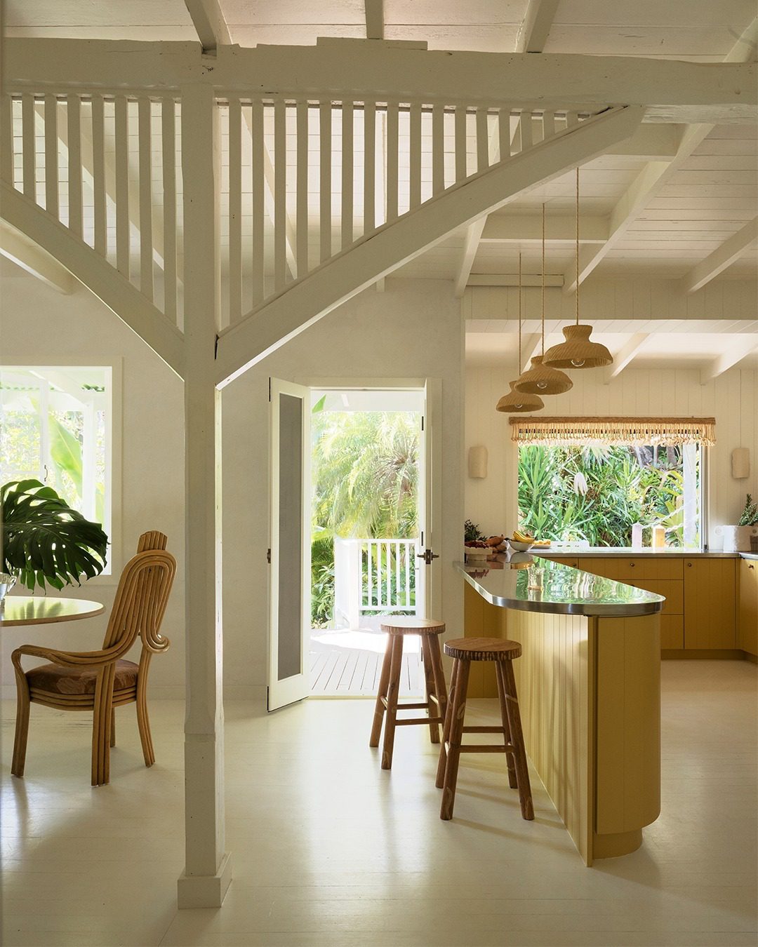 A tranquil, well-lit tropical-inspired kitchen space with white and wood accents