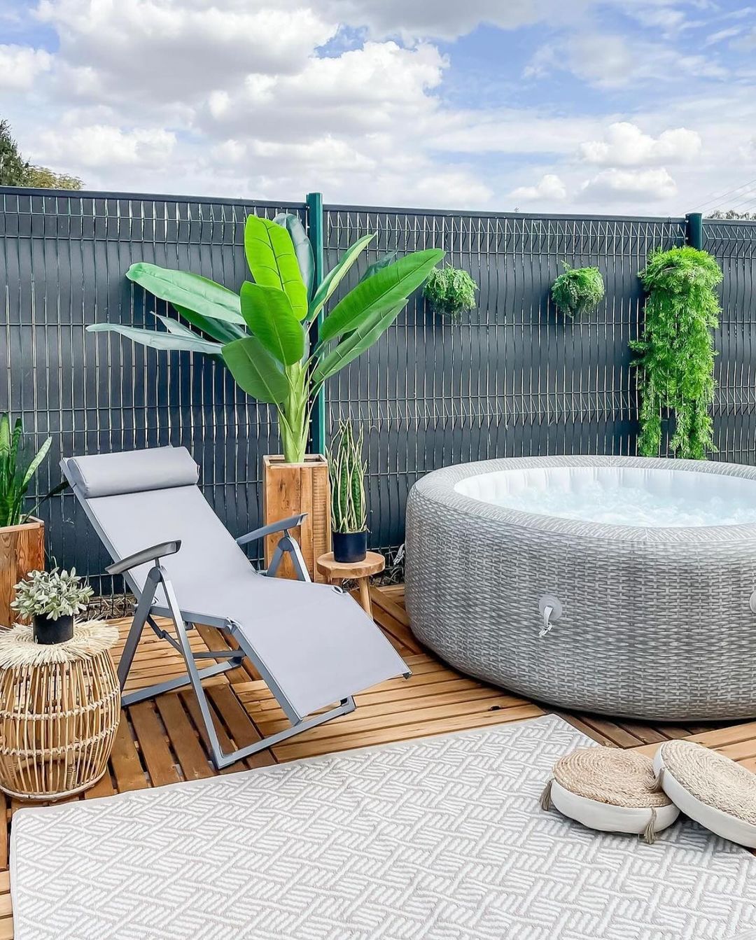 Cozy and inviting outdoor relaxation area with a hot tub and lounger