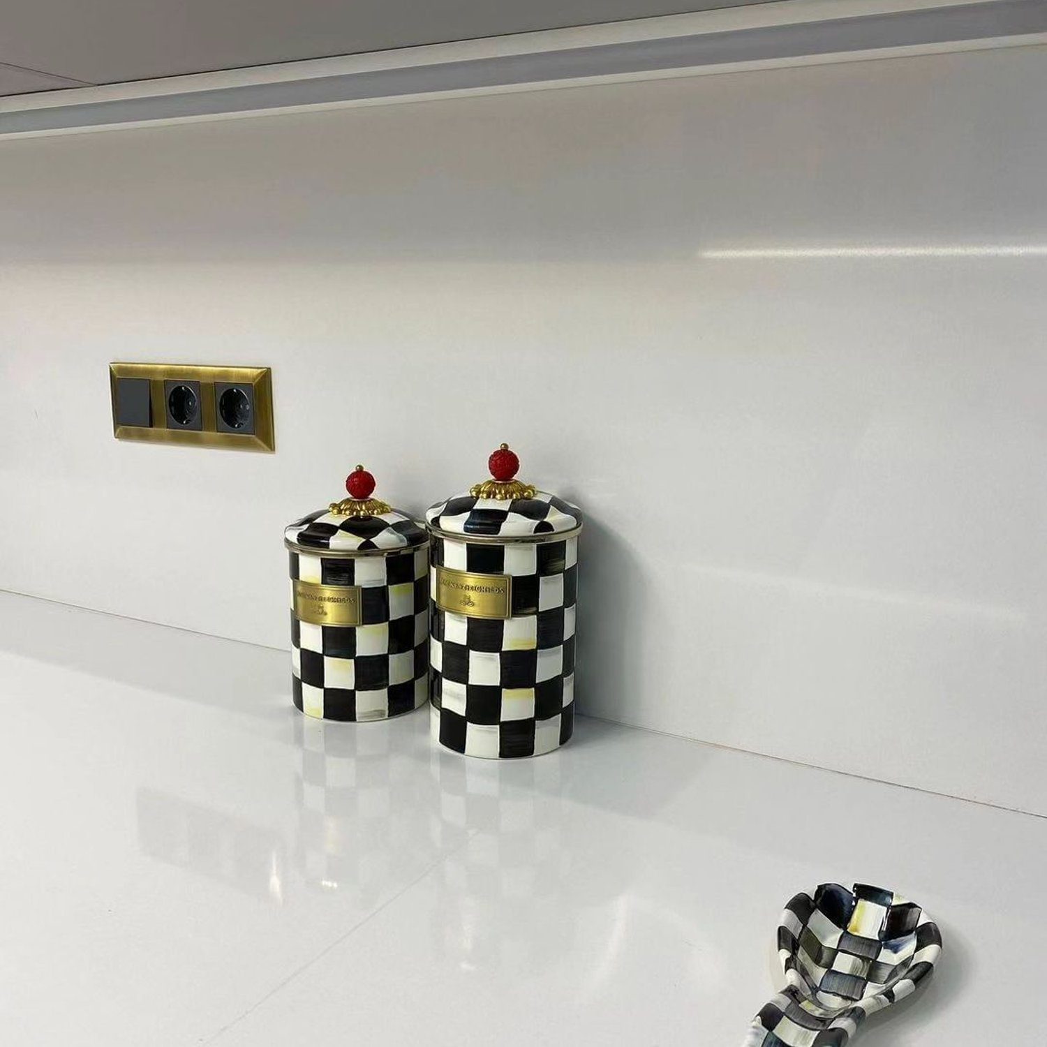 Checkered jars on kitchen countertop