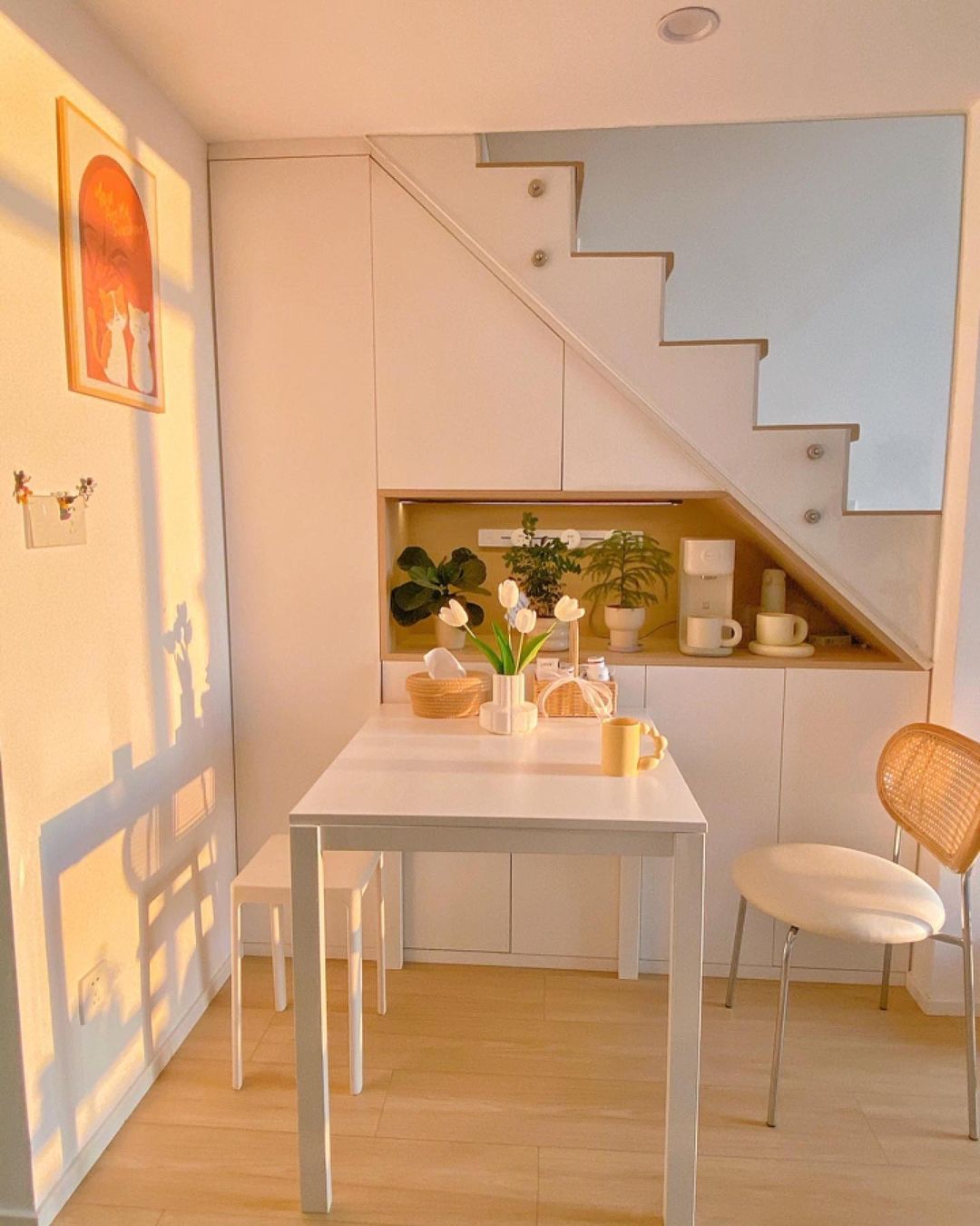 Cozy and illuminated small space with understairs storage and a dining set