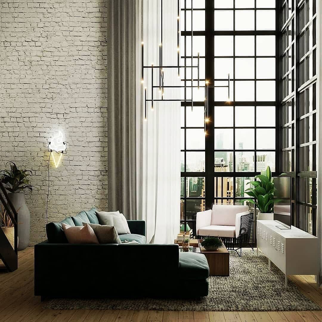 Loft-style living room with large windows and brick wall