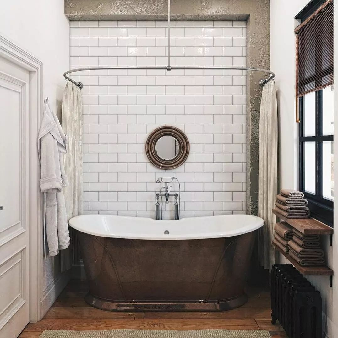 A chic and vintage-inspired bathroom featuring a freestanding copper bathtub