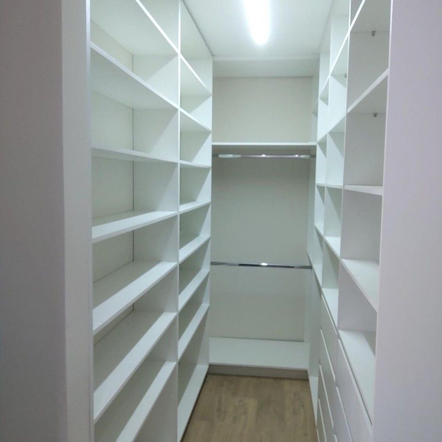 Elegantly designed walk-in closet with ample shelving