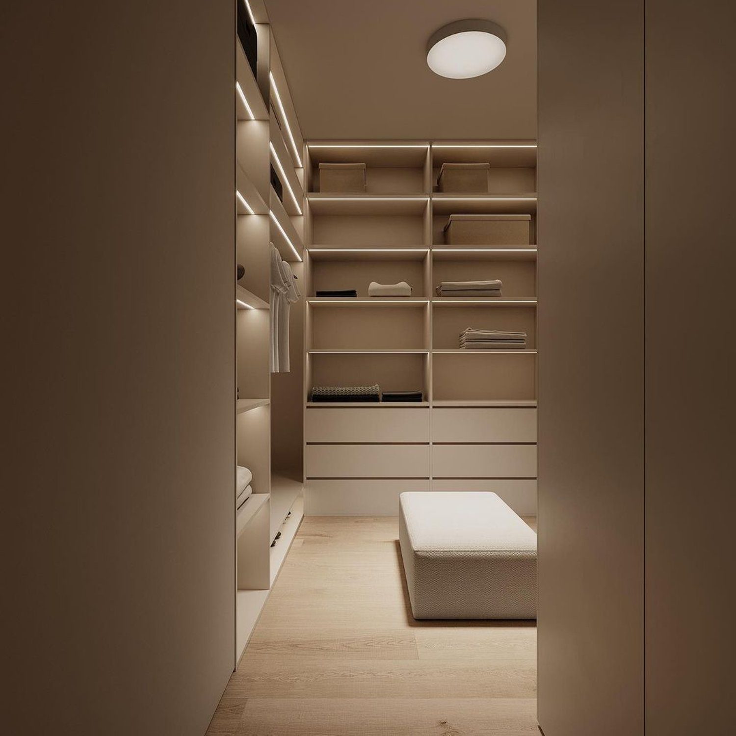 A minimalist walk-in closet showcasing a clean design with ample shelving and a central seating area