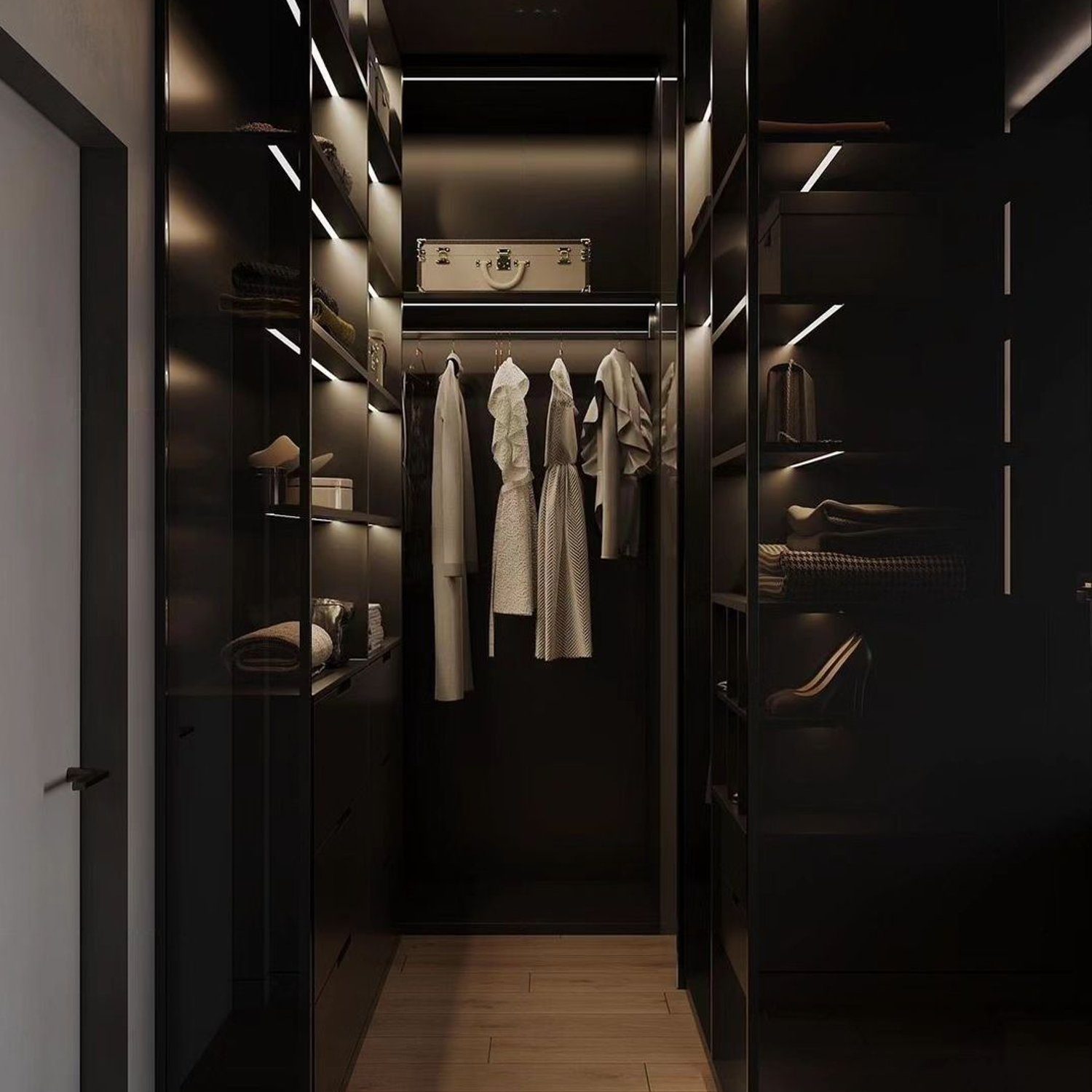 Elegant walk-in closet featuring sleek dark-toned cabinetry