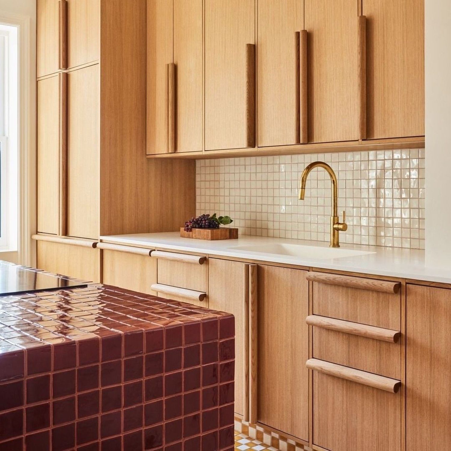 Warm-toned kitchen with seamless cabinets and golden fixtures