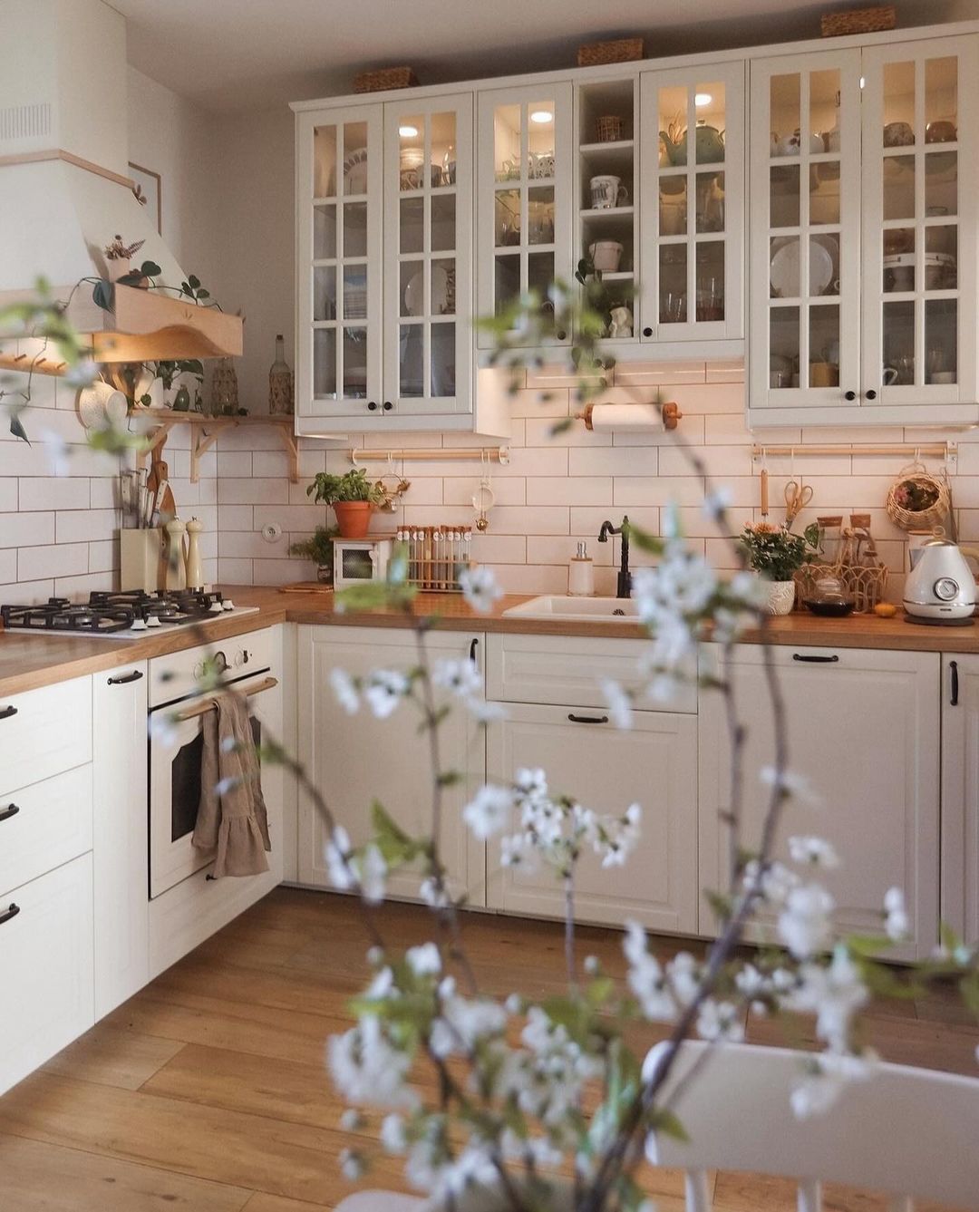 Cozy kitchen with white cabinetry and subway tile backsplash