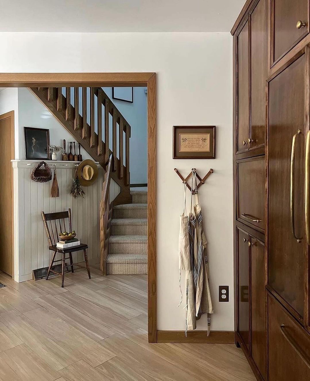 A warmly inviting entryway showcasing a cozy staircase and rustic elements