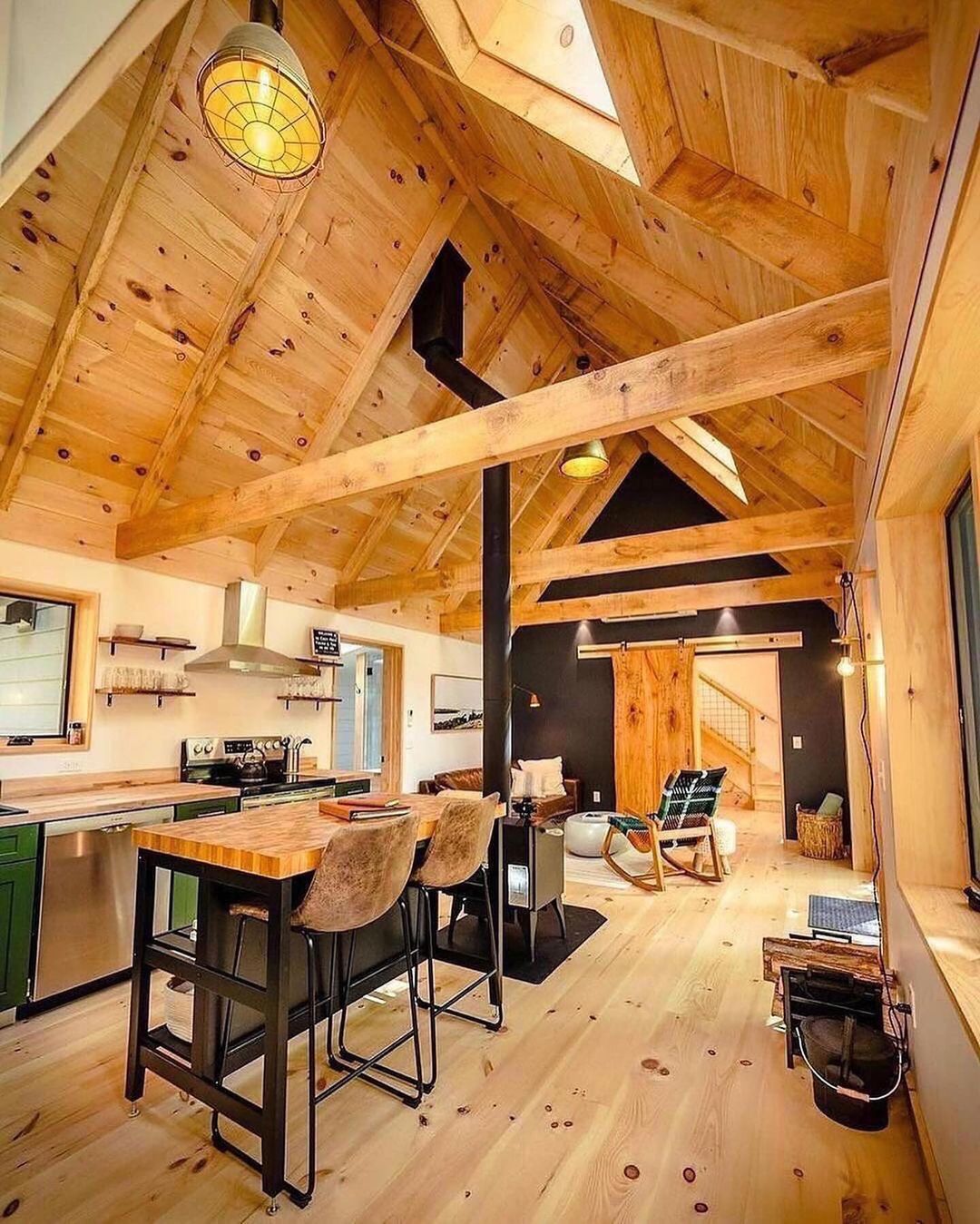 A cozy and inviting wooden interior with a vaulted ceiling and modern touches