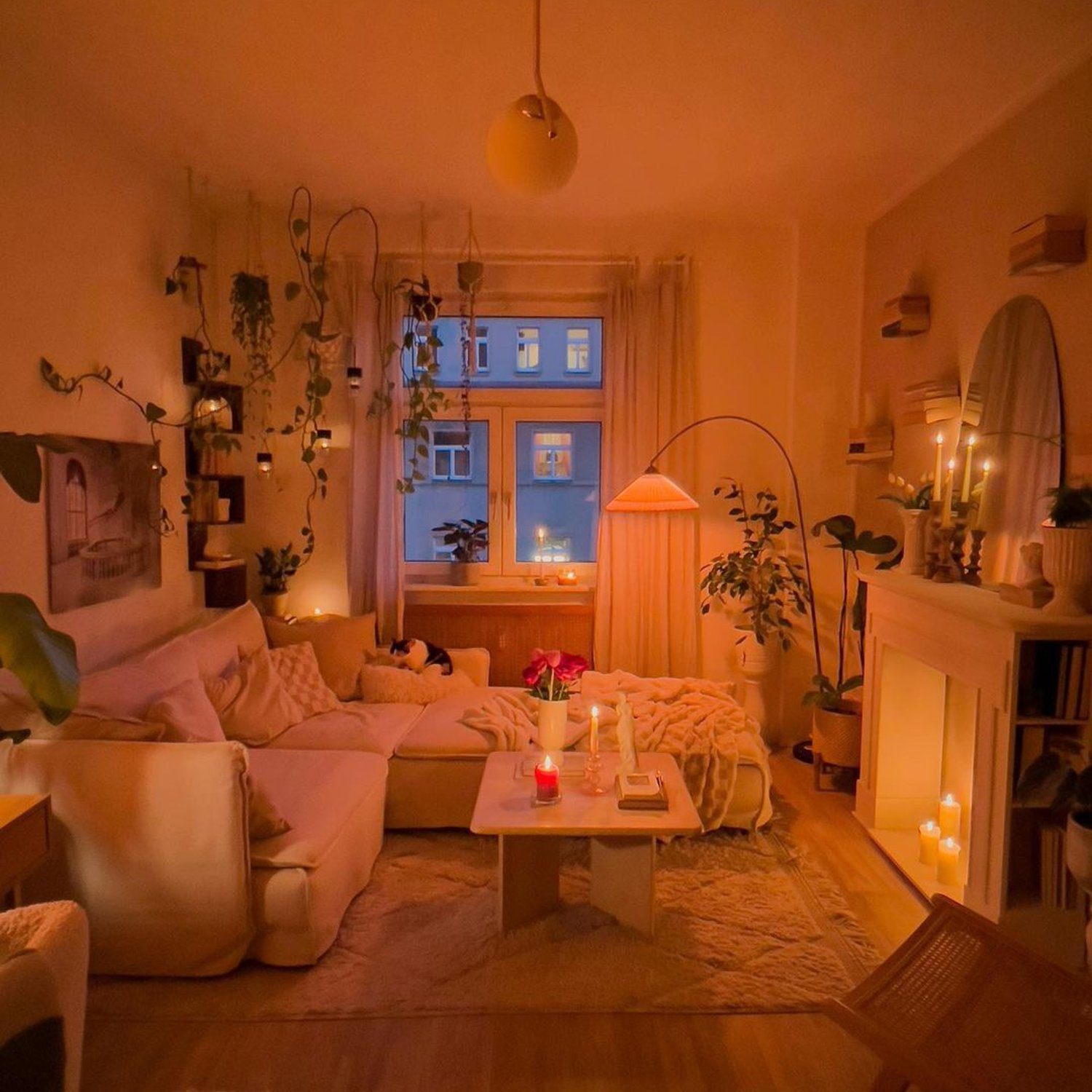 Cozy evening scene in a warmly lit living room with houseplants and soft textures