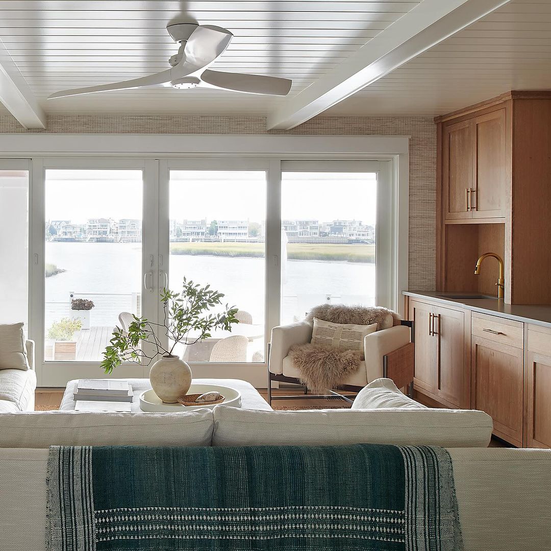 Serene waterfront living room with large windows