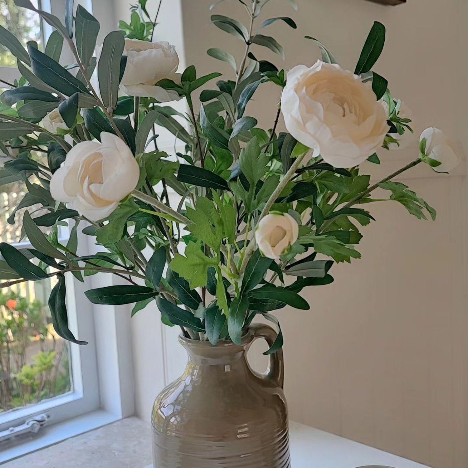 Elegant arrangement of white roses in a ceramic vase