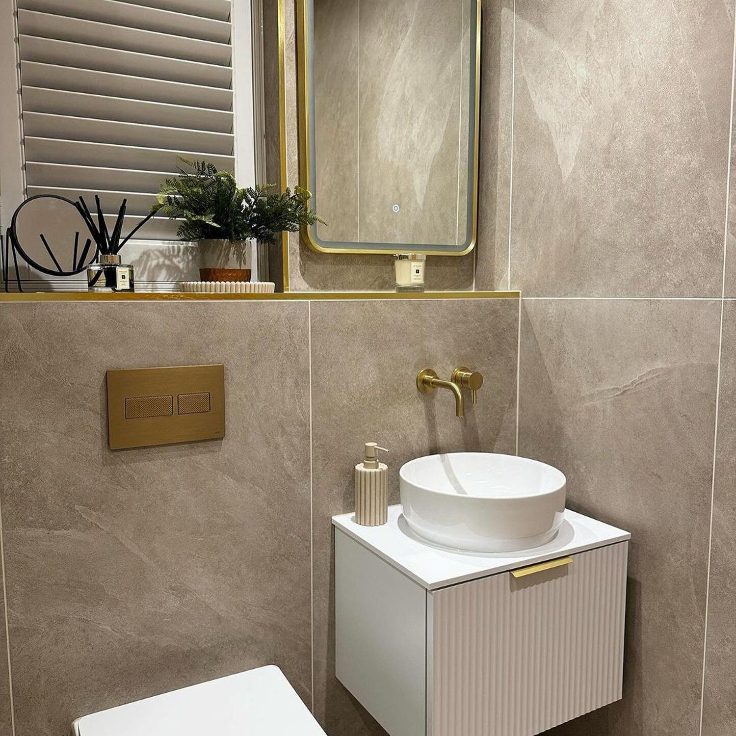 Elegantly designed modern bathroom featuring golden accents