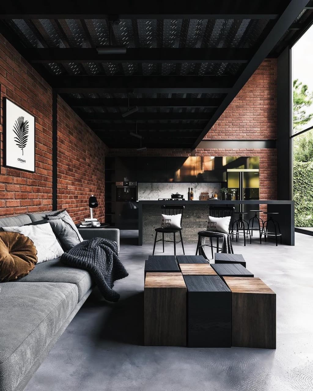 A chic industrial-style living room sporting exposed brick walls, a checkerboard coffee table, and a plush sectional.