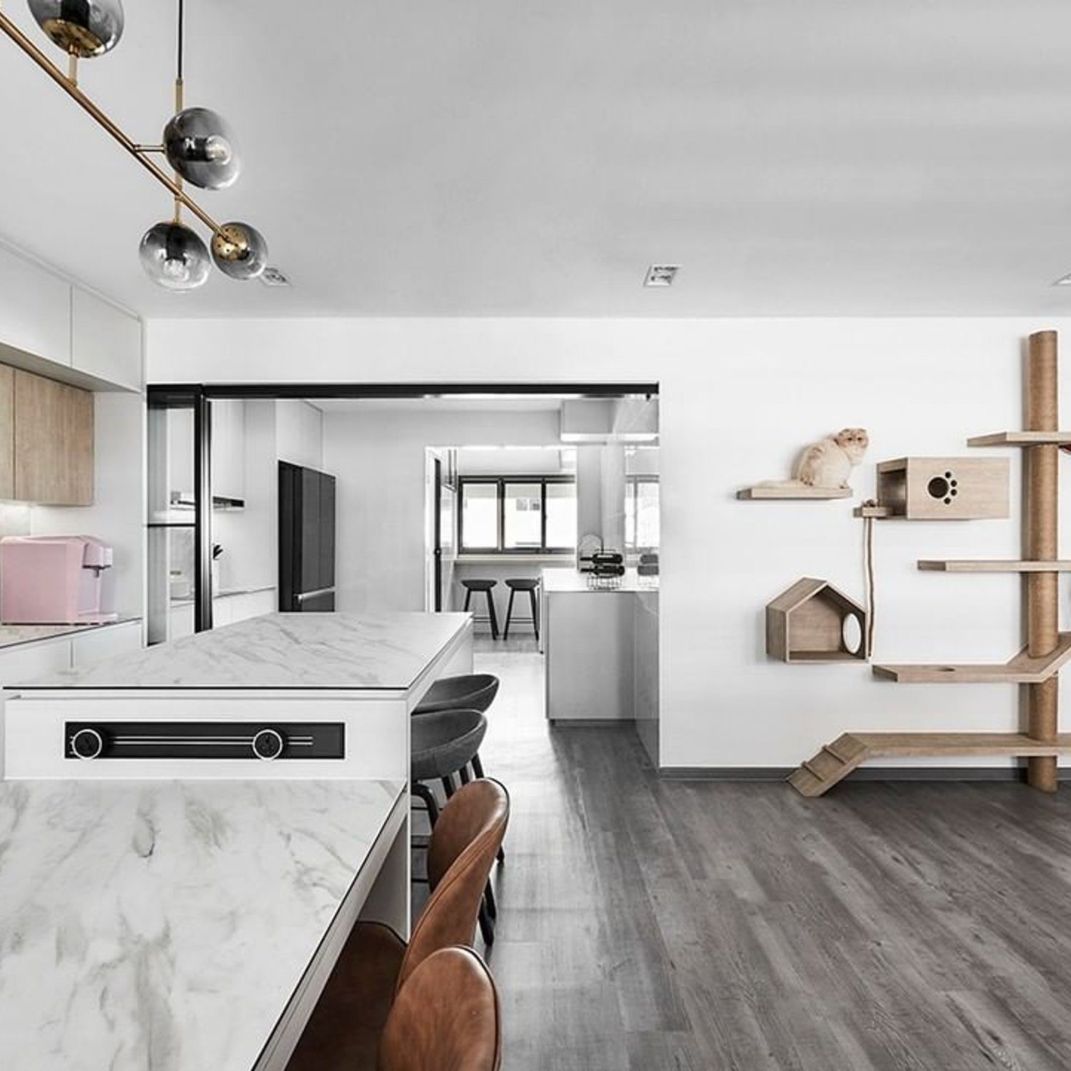 A modern kitchen and living area with a lavish cat tree