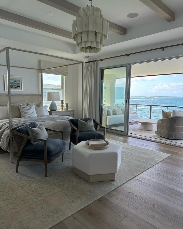 A serene coastal-themed bedroom with expansive ocean views